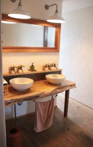 a bathroom with two sinks on a wooden counter at Ruco in Hagi