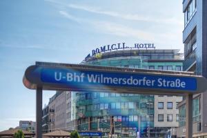 a street sign in front of a large building at Hotel Domicil Berlin by Golden Tulip in Berlin