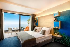 Posteľ alebo postele v izbe v ubytovaní Hotel Ičići - Liburnia
