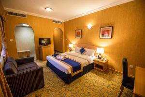 a hotel room with a bed and a chair at Welcome Hotel Apartments 1 in Dubai +38 photos