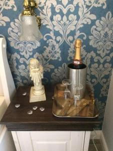 a table with a bottle of champagne and a blender at Pension Schmitz in Serrig