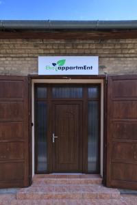 a building with two doors and a sign above it at Ecoappartment 2 in Mosonmagyaróvár