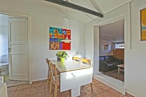 a kitchen with a dining room table and chairs at Strandens Apartment in Ishøj