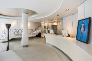 a lobby with a staircase and a painting on the wall at Room Mate Alicia, Madrid in Madrid