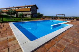 a large swimming pool with a playground at Hospederia Parque de Monfragüe in Torrejón el Rubio