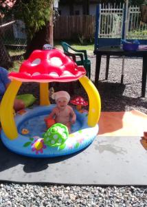 a baby in a pool in a mushroom house at Palm trees in Ureki