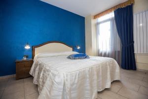 Postel nebo postele na pokoji v ubytování B&B Fior Tramonti