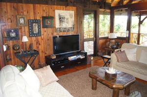 a living room with a couch and a tv at House 23 Ezulwini in Sodwana Bay Lodge in Sodwana Bay