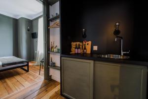 a kitchen with a counter with a sink in a room at Mouse House Kapana in Plovdiv