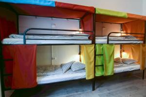 two bunk beds with their doors open in a room at Pal's Mini Hostel in Budapest
