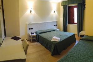 a hotel room with a bed and a table at Hotel San Berardo in Pescina