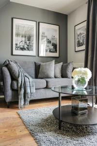 a living room with a gray couch and a glass table at Ludwina House in Birmingham