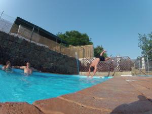 a group of people swimming in a swimming pool at Hotel Zebetinsky Dvur Brno in Brno