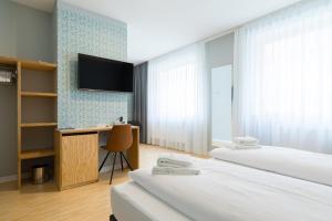 Postel nebo postele na pokoji v ubytování mk | hotel münchen city + 37 fotografií