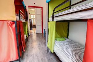 a room with two bunk beds and a wooden floor at Pal's Mini Hostel in Budapest