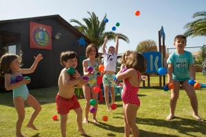 a group of children playing with balls in a park at Royal Hideaway Sancti Petri in Chiclana de la Frontera