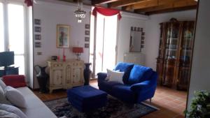 イゼーオにあるAppartamento Piuisnaのリビングルーム(青い椅子、ソファ付)