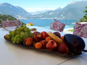 a tray of fruit on a table with a view at Villa Silvi piscina sauna e hot tub in Perledo