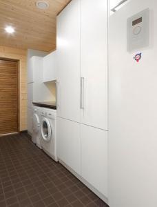 a laundry room with a washer and a washing machine at Naava Resort in Ähtäri