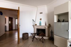 a living room with white walls and a fireplace at Casa das Conchas in Ericeira