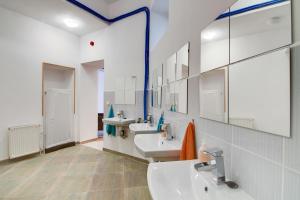 a bathroom with two sinks and two mirrors at Pal's Mini Hostel in Budapest