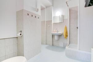 a bathroom with a toilet and a sink and a shower at Pal's Mini Hostel in Budapest