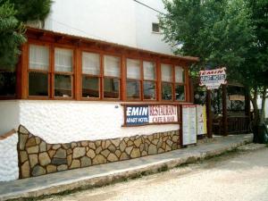 a building with signs on the side of it at Emin Apart Hotel in Didim