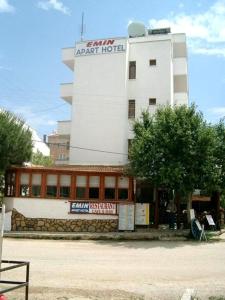 a building with a sign on the front of it at Emin Apart Hotel in Didim