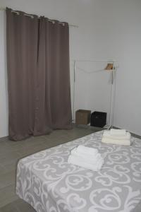 a bedroom with a bed with towels on it at Tra mare e profumi in Trapani