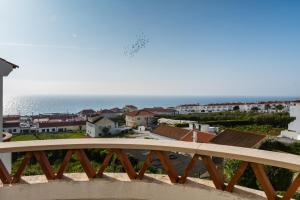 a view of the ocean from a balcony at Casa das Conchas in Ericeira