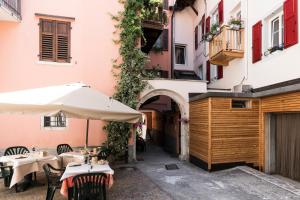 an outdoor restaurant with tables and an umbrella at San Giorgio in Borgo