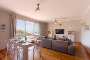 a living room with a couch and a table with chairs at Peace Haven in Calheta