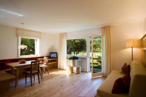 a living room with a table and a dining room at Residence Gustav Thoeni in Prato allo Stelvio