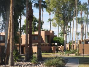 a building with palm trees in front of it at McCormick Ranch Golf Villa in Scottsdale