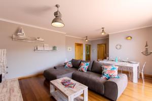 a living room with a couch and a table at Peace Haven in Calheta