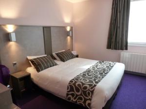 a bedroom with a large bed and a window at Tourhotel Blois in La Chaussée-Saint-Victor