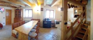 a kitchen with a long wooden table in a room at Chalet Immerso nel Verde in Strembo