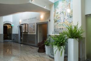 a lobby with two potted plants in a building at Hotel Delle Terme Santa Agnese in Bagno di Romagna +61 photos