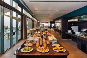 a buffet line with food and drinks on a table at Occidental Faro in Faro