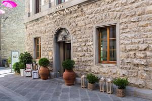 a stone building with plants in front of it at Hotel Delle Terme Santa Agnese in Bagno di Romagna