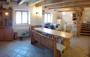 a kitchen with a wooden table and a dining room at Chalet Immerso nel Verde in Strembo