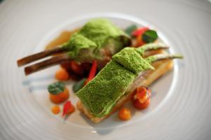 a white plate with a piece of food on it at Occidental Faro in Faro