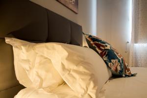 a bed with a headboard and two pillows on it at Peace Haven in Calheta +12 photos