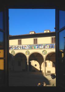 a view of a building with people on a bridge at Appartamento Il Fregio in Pistoia