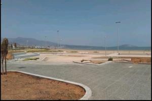 a empty parking lot with a skate park in the distance at Appartement a Nador in Nador