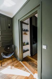 a room with a chair and a sliding glass door at Mouse House Kapana in Plovdiv