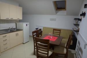 a kitchen with a table and chairs and a refrigerator at Hostel Tuba in Pristina
