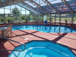 a large swimming pool with a glass ceiling at Baymont by Wyndham Sullivan in Sullivan