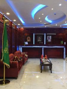 a living room with couches and a table in a room at Dana North in Al Qurayyat