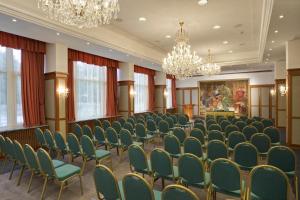 a conference room with chairs and a chandelier at Ensana Thermal Hévíz in Hévíz +29 photos